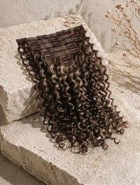 Clip-in hair extensions weft with tight curly dark-brown hair