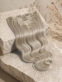 Clip-in hair extensions weft with long body-wave curls, ash blonde