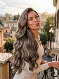 Wavy seamless clip-in extensions, long cool ash gray hair styled on model