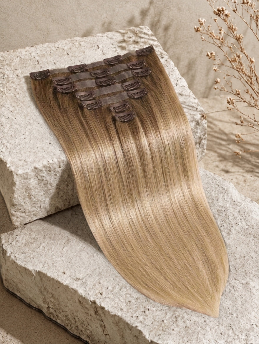 Seamless clip-in hair extensions in light brown blonde, straight long weft with clips