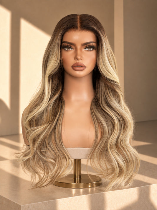 Lia lace wig on stand with long wavy blonde hair and darker roots