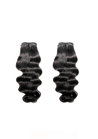 Two black body-wave hair bundles with natural loose waves, weft at top
