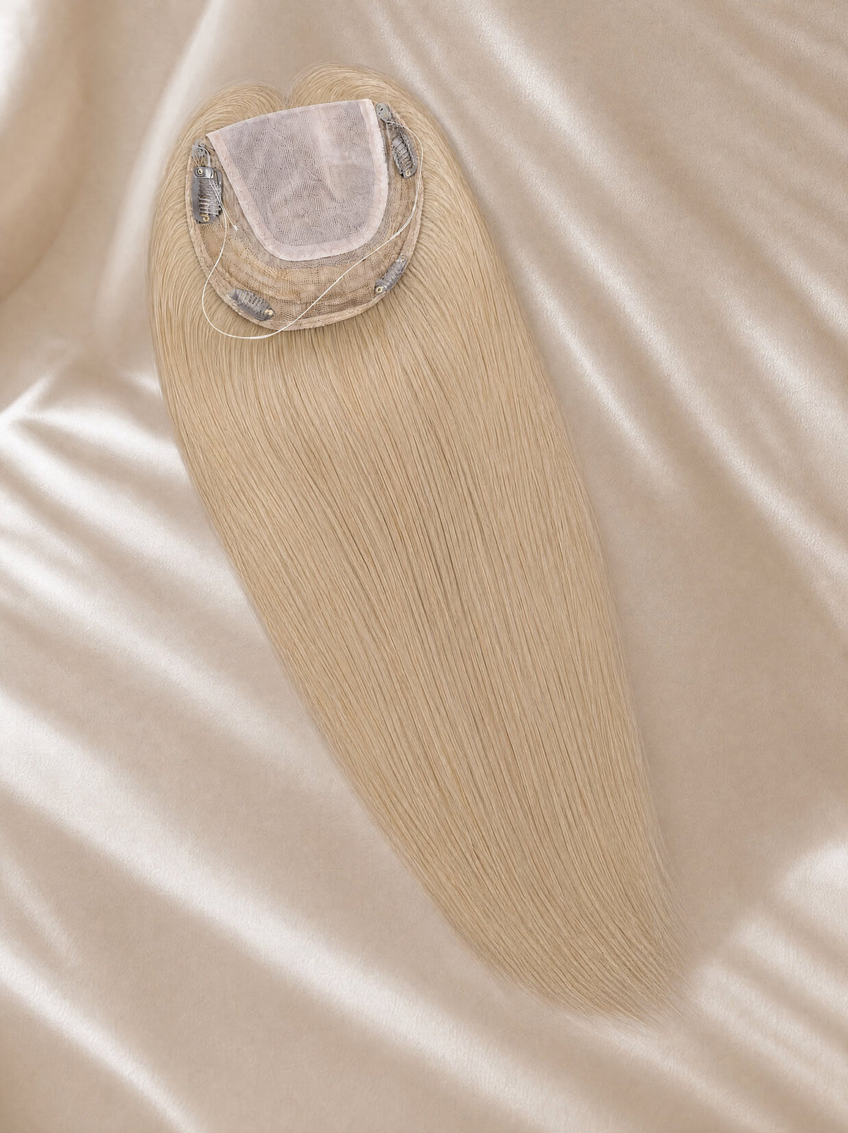 Light-blonde lace hair topper with visible lace base and fine hair strands