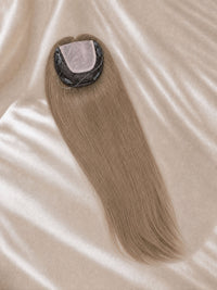 Light-blonde lace hair topper with circular lace base and smooth, straight strands