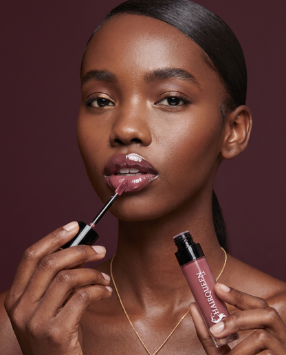 Lip kit plum lipstick and gloss swatches on lips, with applicator and tube