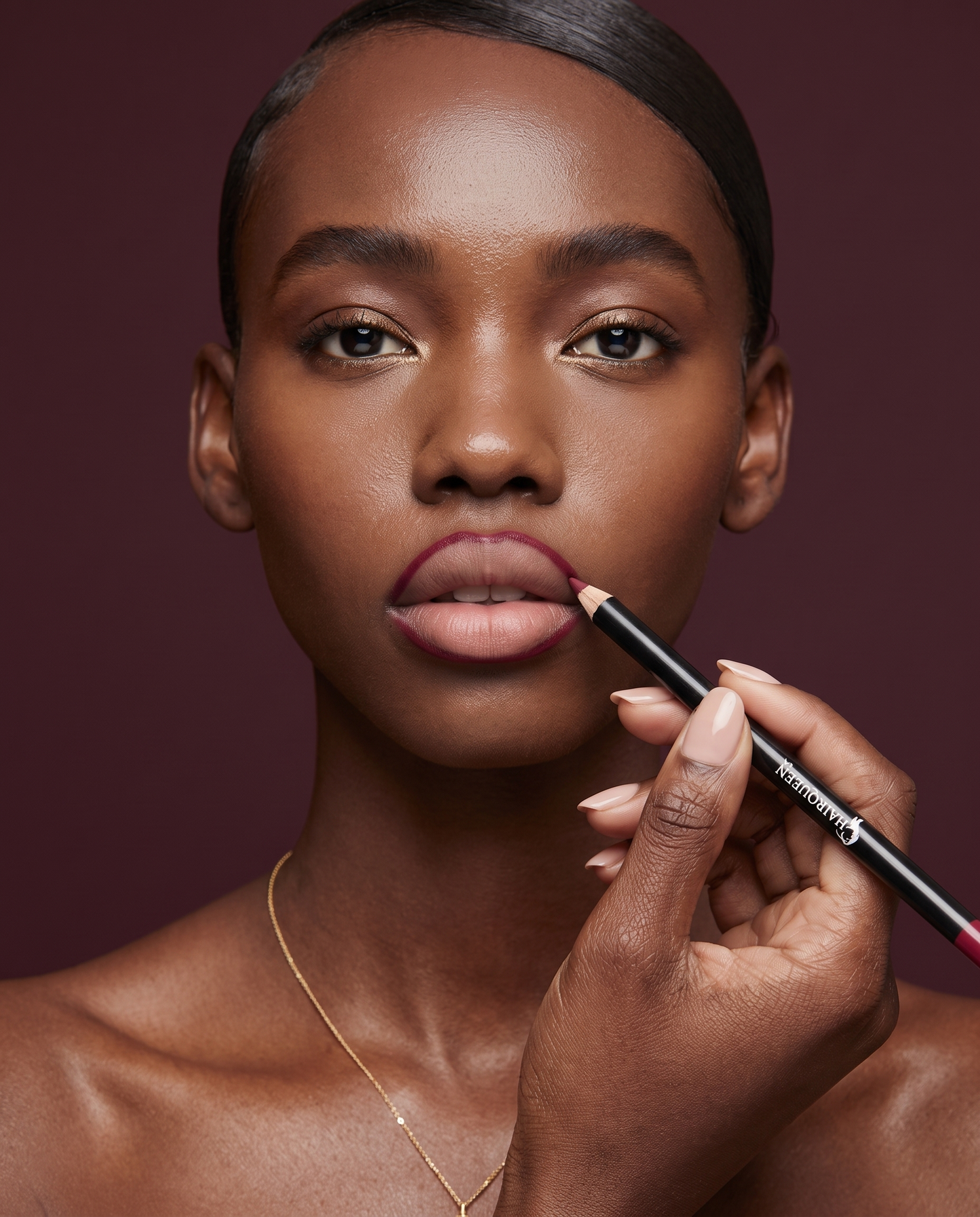 Lip kit plum matte lipstick applied to natural lips, with applicator in hand