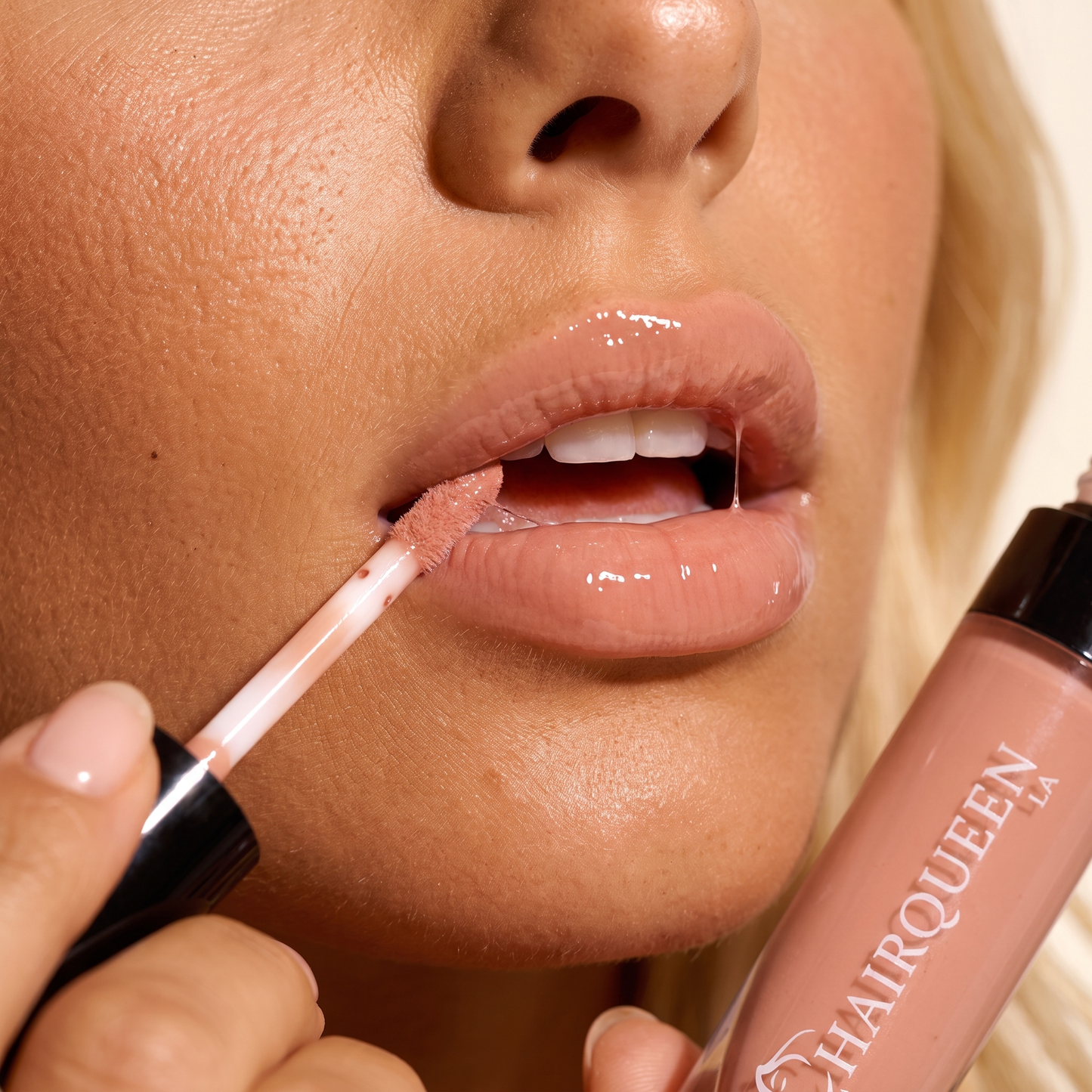 Nude pink lip gloss on lips with lip liner and angled applicator brush