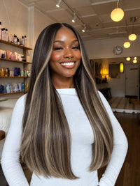 Long straight highlighted hair on a model in dark ash blonde tones