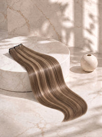 Sleek body wave hair bundle in medium brown with light blonde blend highlights