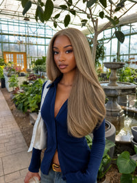 Long straight hair in cool light blonde blend on a model, side-part style