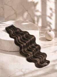 Dark brown wavy hair bundle laid on display with defined S-shaped waves.