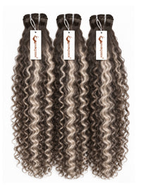 Three hair bundles with curly dark brown and gray highlights, with tags