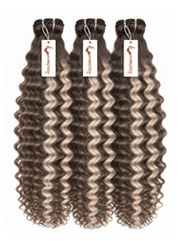 Three hair bundles with curly dark brown and gray highlights, with product tags