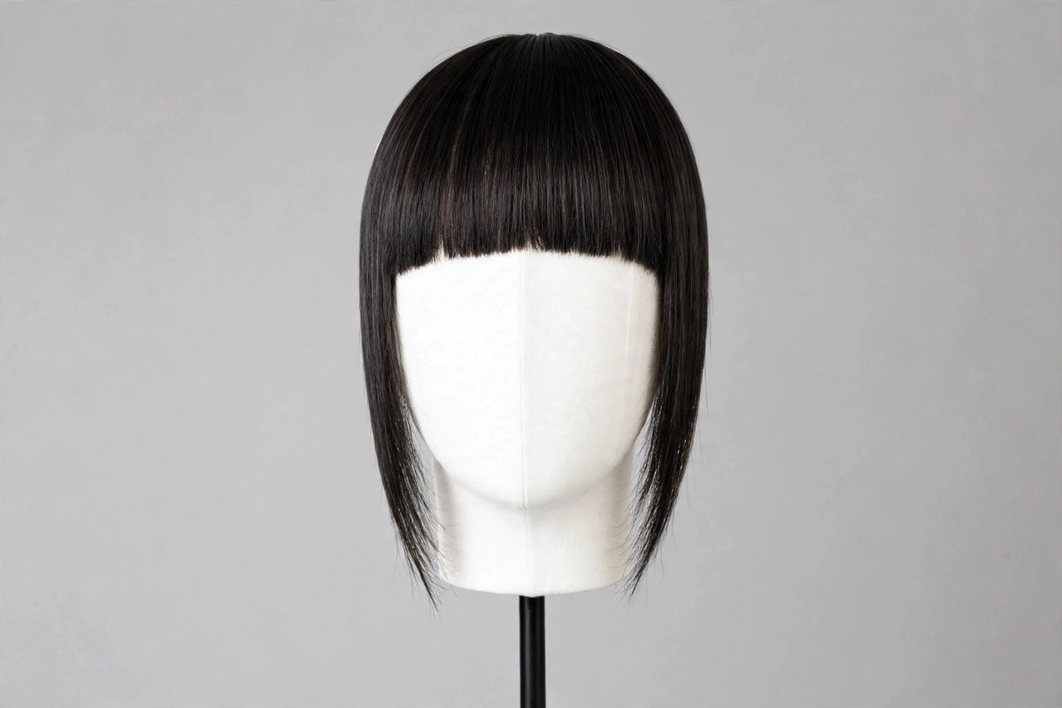 Straight black bangs on mannequin head, full fringe with blunt ends