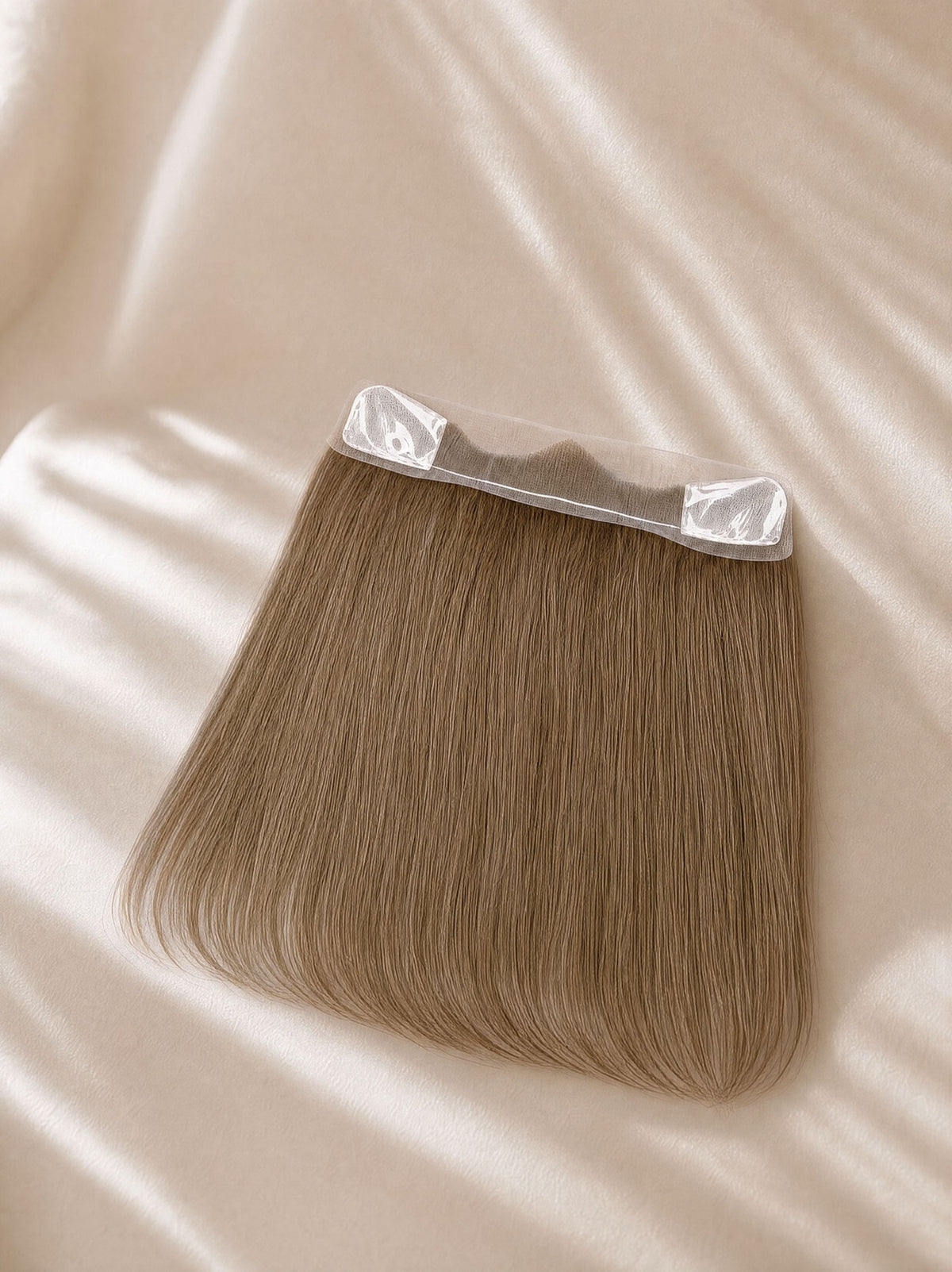 Lace hairline topper with straight medium-brown hair and transparent tape tabs at top