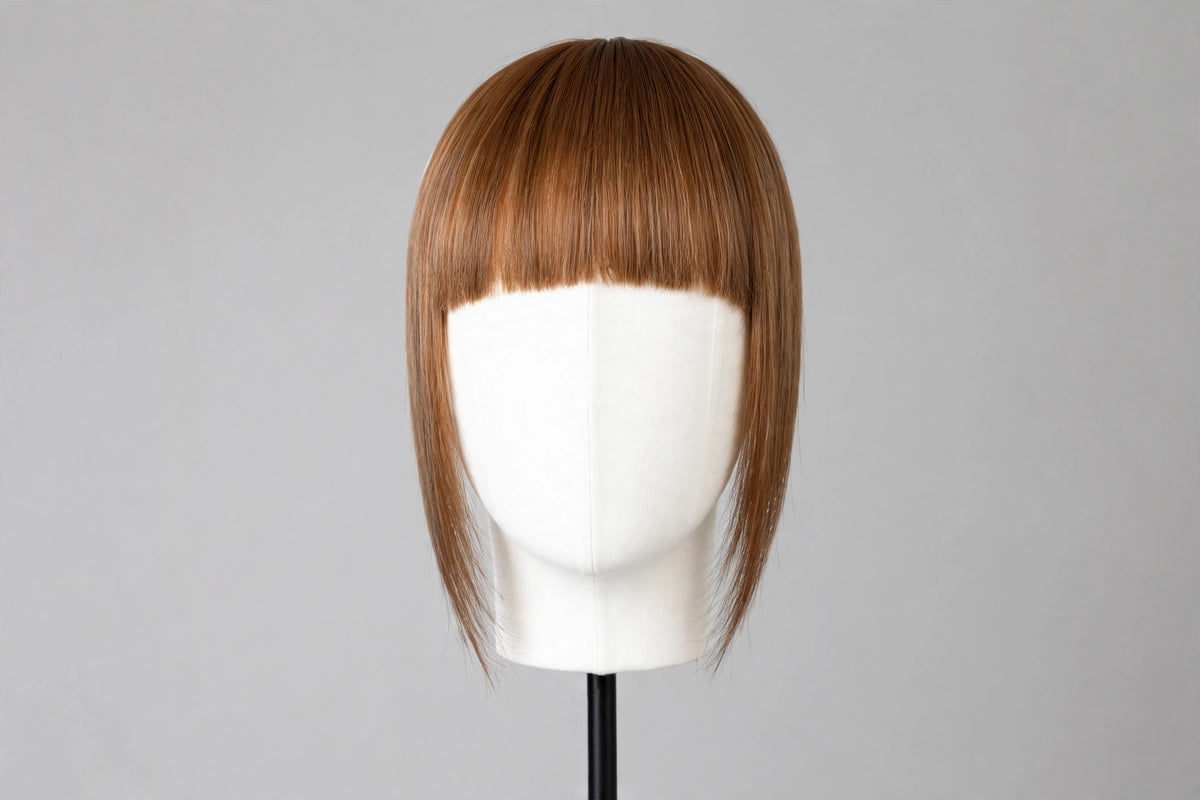 Straight chestnut bangs on mannequin head, blunt fringe with even length