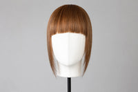 Straight chestnut bangs on mannequin head, blunt fringe with even length