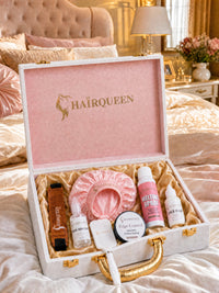 Wig care essentials kit in open case with pink satin bonnet and multiple hair product bottles