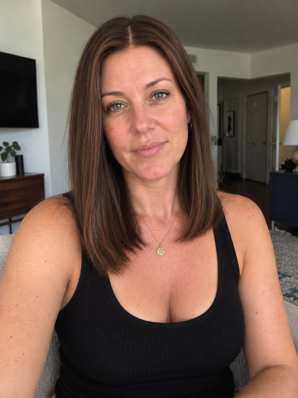 Shoulder-length dark brown lace-front wig with center part, worn by model