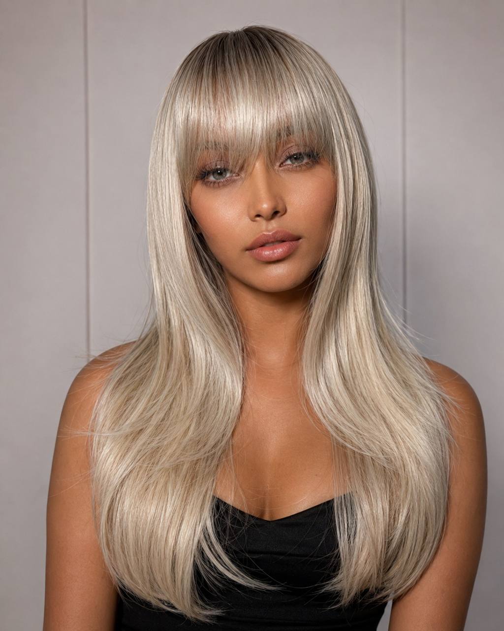 Long straight lace wig with silver-blonde hair and blunt bangs, close-up on model.