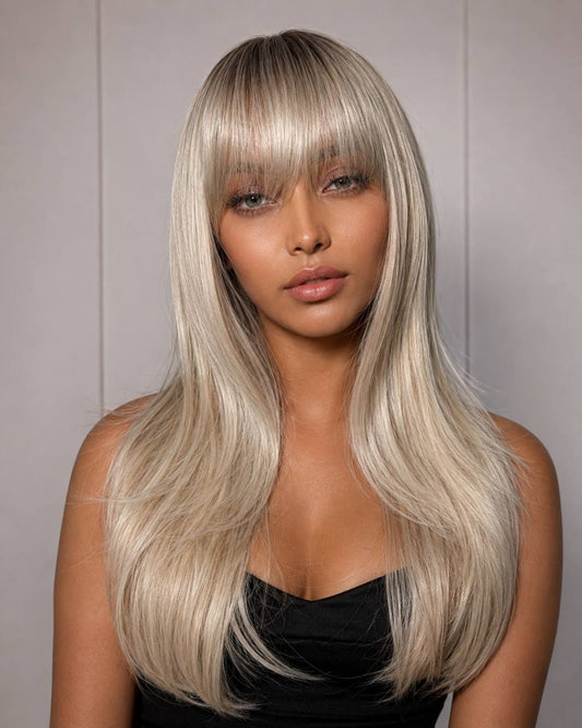 Long straight lace wig with silver-blonde hair and blunt bangs, close-up on model.