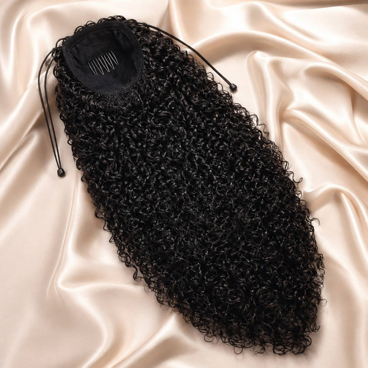 Black curly ponytail extension hairpiece with drawstring cap, coiled texture