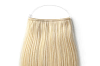 Straight blonde halo hair extension with ring-style attachment and long straight strands