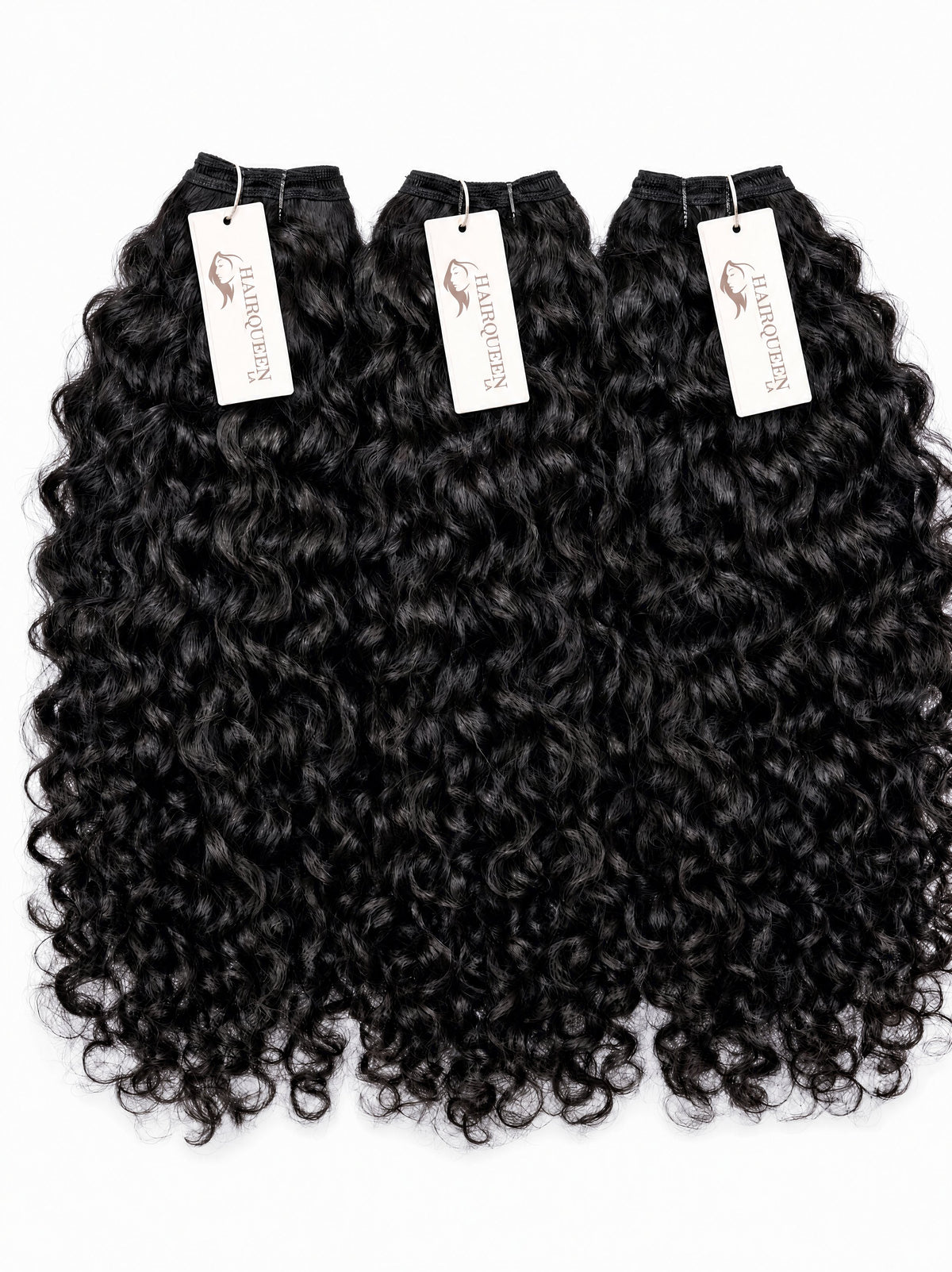 Black curly human hair bundles, 4 pieces with white brand tags.
