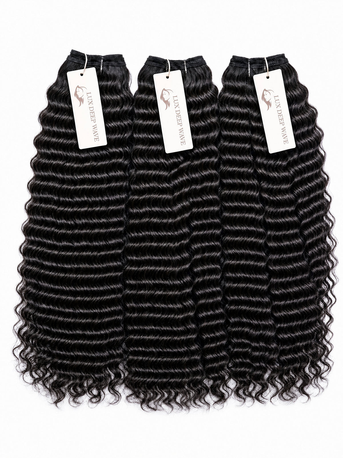 Black deep-wave human hair bundles with ringlet texture, 4 pieces with white tags.