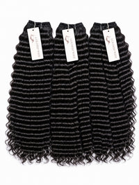 Black deep-wave human hair bundles with ringlet texture, 4 pieces with white tags.
