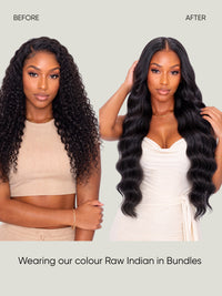 Long dark wavy hair extensions in bundles, styled with loose waves and center part.