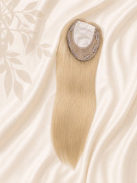 Light blonde hair topper showing sheer silk base top and attachment clips