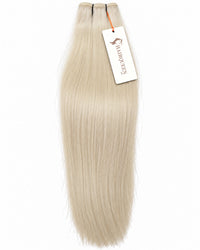 Light blonde hair weft with straight strands and top stitched closure.