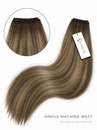 Single machine weft hair bundle in dark brown with rooted honey tones, wavy strands.