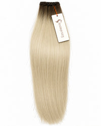 Hair extension weft in pale blonde, straight long strands with dark cap.