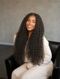 Straight tape-in hair extensions, long curly black hair texture, full voluminous curls