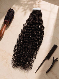 Curly tape-in hair extension in dark brown, with tape tabs and matching clips