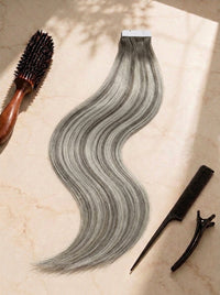 Tape-in hair extensions in ash gray, long wavy weft with tape top edge