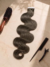 Body wave tape-in hair extension weft, dark brown wavy hair with tape strip attached