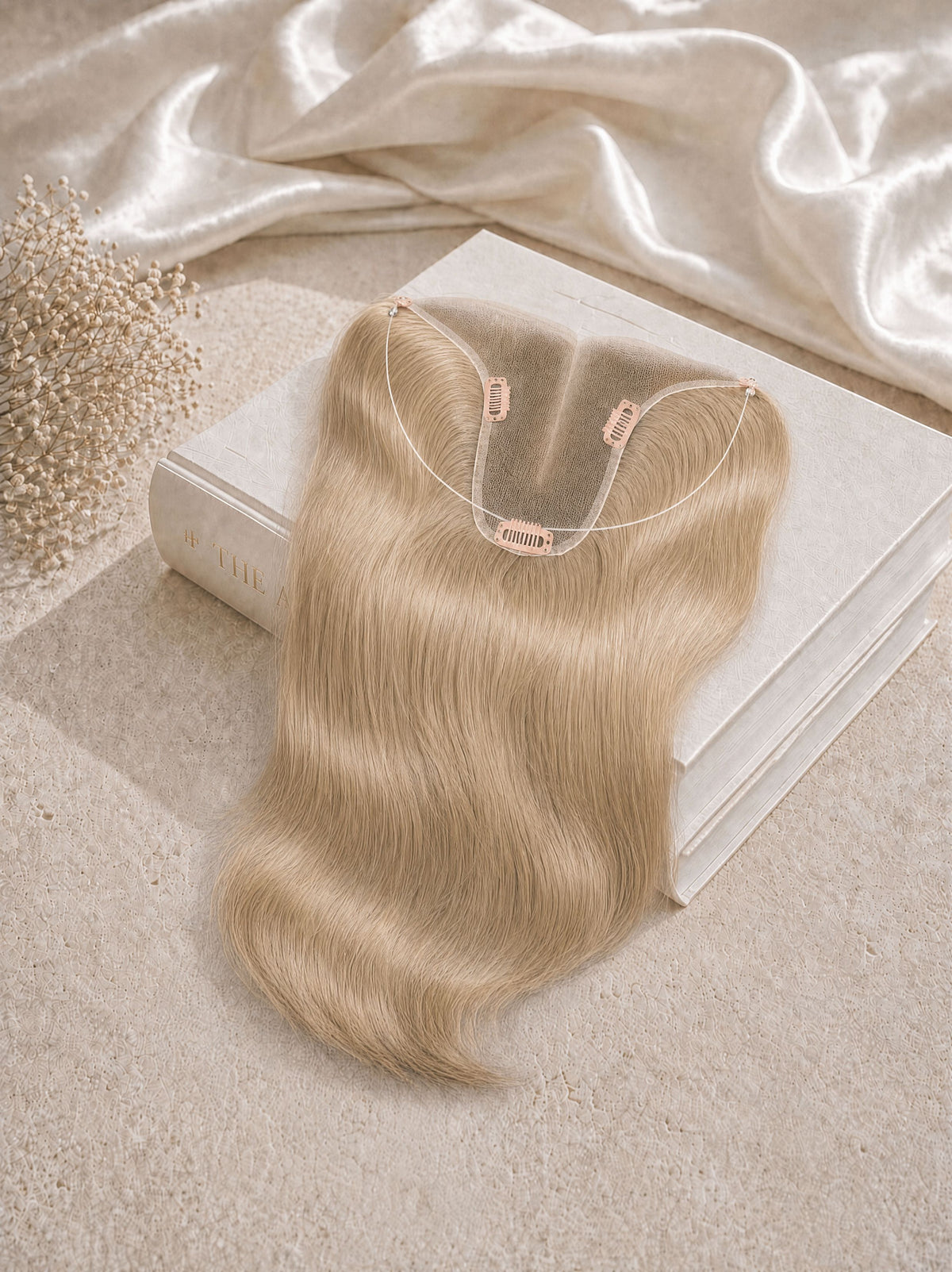 Hair topper extension in light blonde, wavy hair with U-shaped attachment clips.