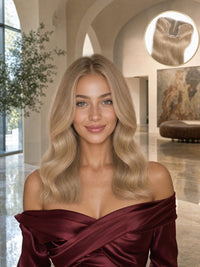 Light blonde hair topper with long loose waves on a model