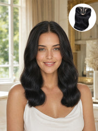 Hair topper on model with dark, voluminous wavy hair framing the face.