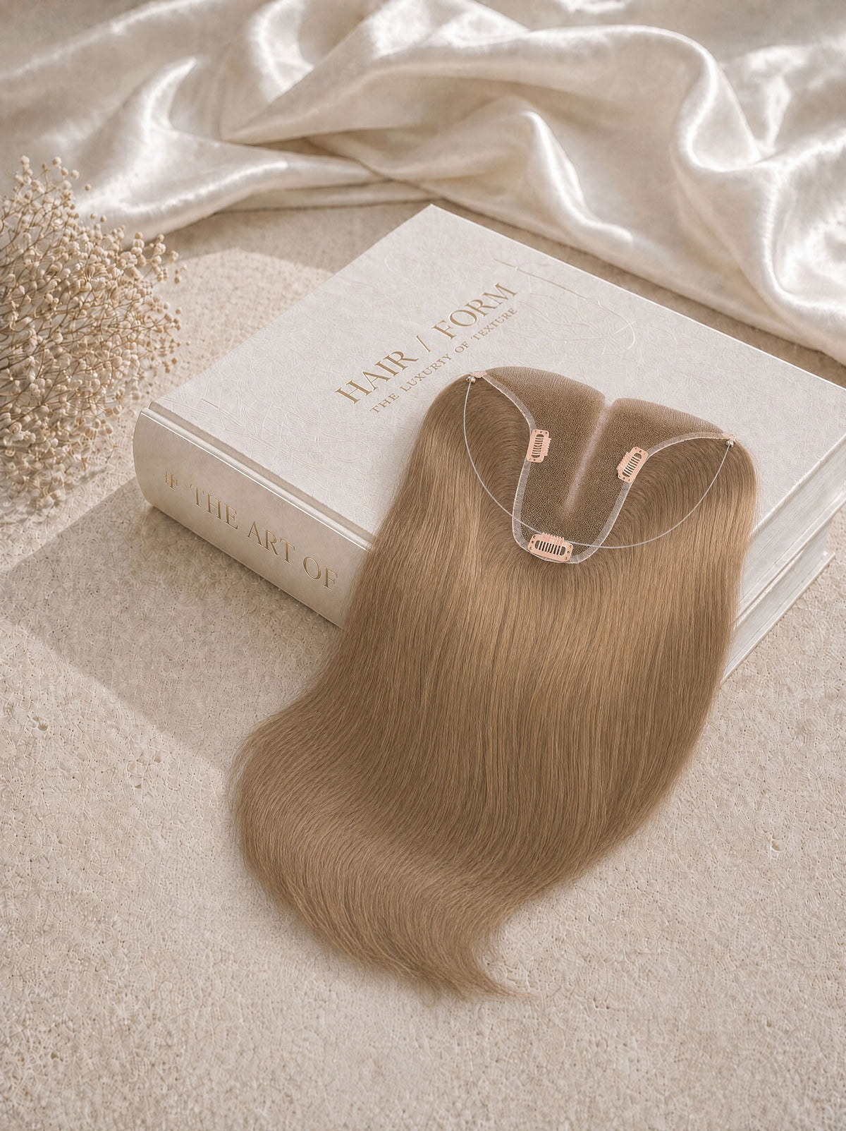 Light blonde hair topper extension in box, showing halo wire and clips on top.