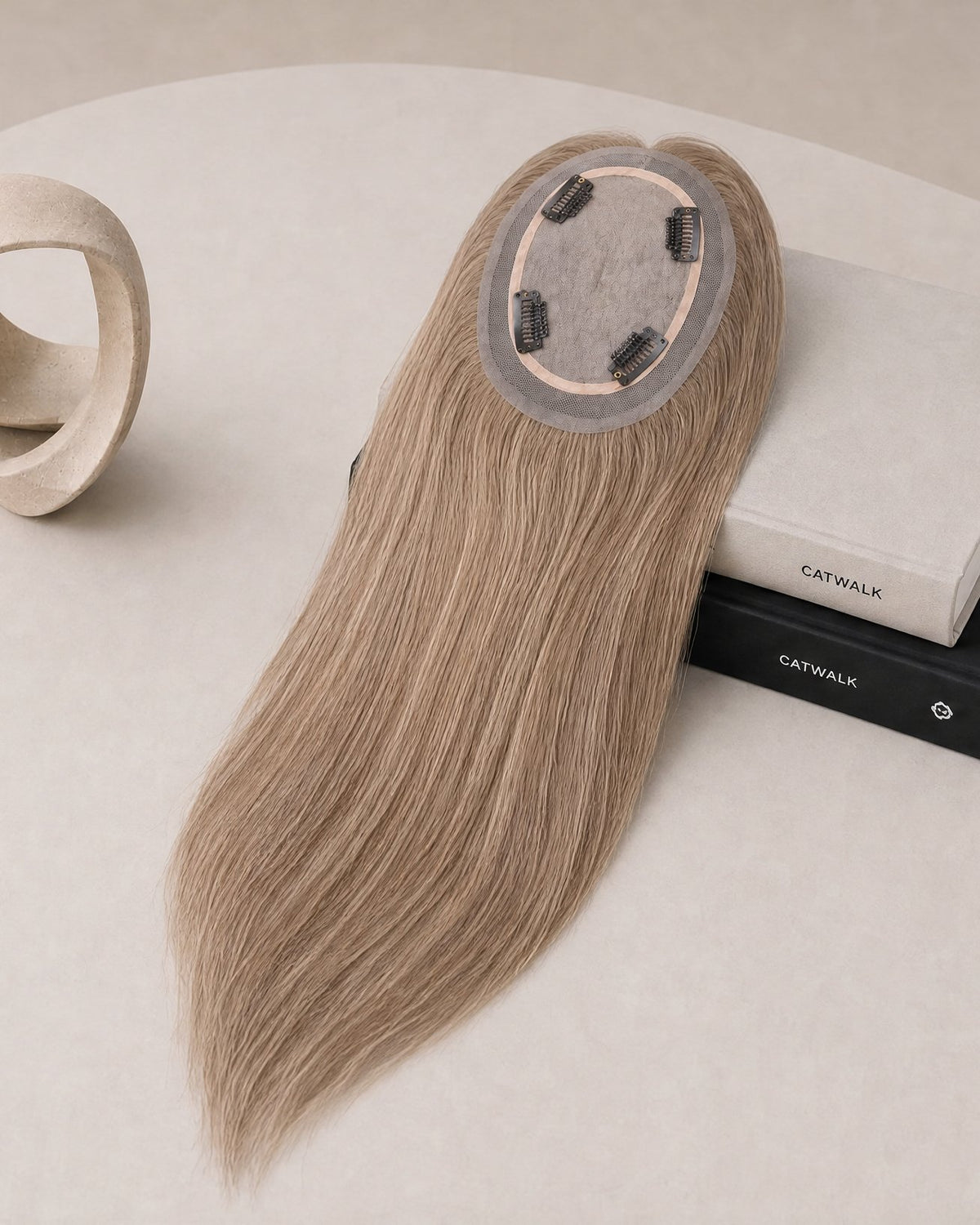 Light blonde hair topper underside, round lace base with clip detail