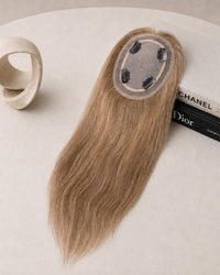 Light blonde hair topper with oval lace cap and long straight strands.