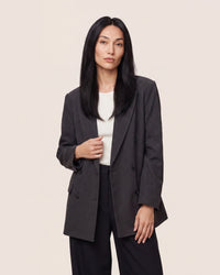 Hair topper with long straight black hair, worn with a side-part look