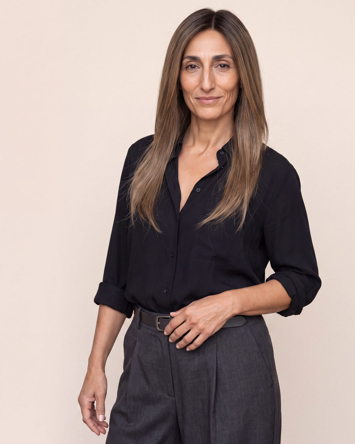 Hair topper with long straight dark brown hair, center-part look on model