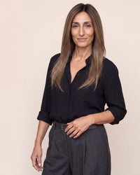 Hair topper with long straight dark brown hair, center-part look on model