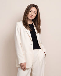 Hair topper with long straight dark brown hair, worn with a side-part look