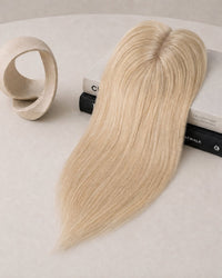 Platinum blonde hair topper with clear base and three fastening clips